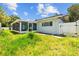 Exterior showing the backyard with an enclosed porch and white fence, offering a private outdoor space at 2302 16 W St, Palmetto, FL 34221