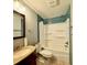 Bathroom with blue tile accent, updated fixtures, and bathtub shower combo at 2302 16 W St, Palmetto, FL 34221