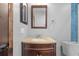 Bathroom with vanity and granite top, framed mirror, chrome accents, and blue tile at 2302 16 W St, Palmetto, FL 34221