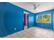 Bedroom featuring tile flooring, fresh blue paint, and a view of the exterior at 2302 16 W St, Palmetto, FL 34221