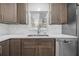 Modern kitchen featuring stainless steel appliances, white countertops, and stylish dark wood cabinets with a window at 2302 16 W St, Palmetto, FL 34221