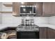 Close-up shot of the kitchen with stainless steel appliances, a modern microwave, and white subway tile backsplash at 2302 16 W St, Palmetto, FL 34221