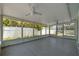 Enclosed porch featuring white ceiling fans and light gray painted concrete floors at 2302 16 W St, Palmetto, FL 34221
