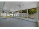 Enclosed porch featuring white ceiling fan, screened windows and painted concrete floors at 2302 16 W St, Palmetto, FL 34221
