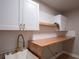 Modern laundry room with white cabinets, butcher block counters, and white subway tile at 2435 Hawk Griffin Rd, Plant City, FL 33565