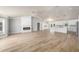 Spacious open-plan living room with a modern fireplace, wood floors and easy access to the kitchen at 2435 Hawk Griffin Rd, Plant City, FL 33565