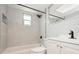 Bright bathroom with marble tile, black fixtures, and a built-in shower niche at 4651 Helena Ne St, St Petersburg, FL 33703