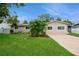 Charming single-story home with a well-manicured lawn, mature landscaping, and a welcoming driveway at 4651 Helena Ne St, St Petersburg, FL 33703