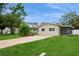 Charming single-story home boasts a spacious front yard, mature trees, and an enclosed porch at 4651 Helena Ne St, St Petersburg, FL 33703