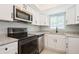 Modern kitchen showcasing stainless steel appliances and granite countertops at 4651 Helena Ne St, St Petersburg, FL 33703