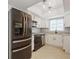 Well-lit kitchen with stainless steel appliances, white cabinetry, and granite countertops at 4651 Helena Ne St, St Petersburg, FL 33703