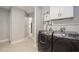 Laundry area with machines, cabinets, and a glimpse of the home's interior at 4651 Helena Ne St, St Petersburg, FL 33703
