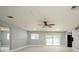 Bright living room with neutral paint, ceiling fan, recessed lighting, and sliding glass doors to the backyard at 4651 Helena Ne St, St Petersburg, FL 33703
