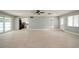 Open living area with tile floors, updated kitchen view, ceiling fan, and access to other rooms at 4651 Helena Ne St, St Petersburg, FL 33703
