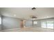 Bright living room with neutral paint, ceiling fan, recessed lighting, and sliding glass doors to outdoor at 4651 Helena Ne St, St Petersburg, FL 33703