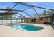 Relaxing outdoor area with a screened-in pool, tile patio, and lush landscaping for privacy at 4651 Helena Ne St, St Petersburg, FL 33703