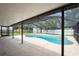 Backyard screened-in pool with concrete deck, perfect for outdoor entertaining at 4651 Helena Ne St, St Petersburg, FL 33703