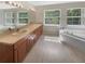 Large bathroom with dual vanities, an oversized mirror, and a separate tub at 915 Woodbridge Ct, Safety Harbor, FL 34695
