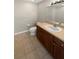 Bathroom with tile flooring, a vanity with dark wood cabinets, and a white toilet at 915 Woodbridge Ct, Safety Harbor, FL 34695