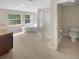 Luxurious bathroom with a dual sink vanity, walk-in shower, garden tub, and private toilet at 915 Woodbridge Ct, Safety Harbor, FL 34695