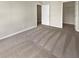 Spacious bedroom featuring neutral paint, neutral carpet, and base molding at 915 Woodbridge Ct, Safety Harbor, FL 34695