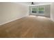 Spacious carpeted bedroom with ceiling fan and a pair of large windows at 915 Woodbridge Ct, Safety Harbor, FL 34695
