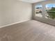 Bright, carpeted bedroom with dual windows and ample natural light at 915 Woodbridge Ct, Safety Harbor, FL 34695