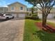 Charming townhome with paver driveway, attached garage, and well-maintained landscaping at 915 Woodbridge Ct, Safety Harbor, FL 34695