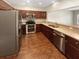 A kitchen with stainless steel appliances, wood cabinets, and light countertops at 915 Woodbridge Ct, Safety Harbor, FL 34695