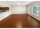 Spacious living area with hardwood floors, a view of the kitchen, and sun filled windows at 915 Woodbridge Ct, Safety Harbor, FL 34695
