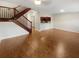Open concept living space with hardwood floors, staircase, and view of the kitchen at 915 Woodbridge Ct, Safety Harbor, FL 34695