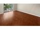 Bright living room with hardwood floors and sliding glass doors to screened patio at 915 Woodbridge Ct, Safety Harbor, FL 34695