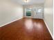 Bright, empty living room featuring gleaming hardwood floors, a ceiling fan and white trim at 915 Woodbridge Ct, Safety Harbor, FL 34695