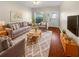 Cozy living room featuring a plush rug, comfortable seating, and a bright, welcoming atmosphere at 915 Woodbridge Ct, Safety Harbor, FL 34695