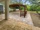 Paver patio with an elaborate covered pergola, bar, and bench at 915 Woodbridge Ct, Safety Harbor, FL 34695