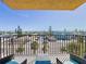 Balcony view of the surrounding neighborhood and ocean in the distance at 14146 Gulf Blvd # 3A, Madeira Beach, FL 33708