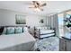 Guest bedroom with one queen bed, one twin bed, and a beautiful view through sliding glass door at 14146 Gulf Blvd # 3A, Madeira Beach, FL 33708