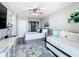 Cozy bedroom with a ceiling fan, rug, and natural light from a door leading to the lanai at 14146 Gulf Blvd # 3A, Madeira Beach, FL 33708