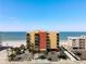 Beachfront condo building with balconies, parking, and palm trees, offering stunning ocean views and easy beach access at 14146 Gulf Blvd # 3A, Madeira Beach, FL 33708