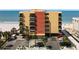 Beachfront condo building with balconies, parking, and palm trees, offering stunning ocean views and easy beach access at 14146 Gulf Blvd # 3A, Madeira Beach, FL 33708
