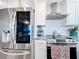 Modern kitchen with stainless steel appliances, granite countertops, white cabinets and modern range hood at 14146 Gulf Blvd # 3A, Madeira Beach, FL 33708