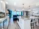 Modern kitchen with granite countertops, stainless steel appliances, and breakfast bar, seamlessly integrated into the living space at 14146 Gulf Blvd # 3A, Madeira Beach, FL 33708