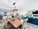 View of open-concept living room features hardwood floors, modern furnishings, and ocean views from the large windows at 14146 Gulf Blvd # 3A, Madeira Beach, FL 33708