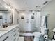 Modern main bathroom featuring a double sink vanity and glass enclosed shower at 14146 Gulf Blvd # 3A, Madeira Beach, FL 33708