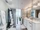 Ensuite bathroom featuring a double sink vanity, glass enclosed shower, and coastal aesthetic at 14146 Gulf Blvd # 3A, Madeira Beach, FL 33708