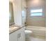 Bright bathroom featuring granite countertops, a bathtub and shower combination, and neutral tile at 1160 Edinburgh St, North Port, FL 34288