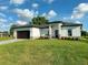 This is a well-maintained single-story home with a spacious lawn, paved driveway, and covered entryway at 1160 Edinburgh St, North Port, FL 34288