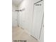Hallway with multiple linen closets providing ample storage at 1160 Edinburgh St, North Port, FL 34288