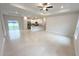 Open-concept living room with recessed lighting open to the kitchen and a sliding glass door at 1160 Edinburgh St, North Port, FL 34288