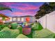 Inviting backyard featuring a modern outdoor fire pit, plush seating, and unique wall mural for relaxation at 9497 122Nd Way, Seminole, FL 33772